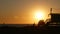 Summertime travel concept. Dark silhouette, iconic retro wooden lifeguard watch tower against sunset orange sky