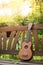 Summertime: Ukulele with yellow sunglasses on a wooden park bench