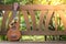 Summertime: Ukulele with yellow sunglasses on a wooden park bench