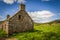 Summery old abandoned Glenfenzie farmhouse ruin in scotland