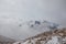 Summit of Cima Undici emerging from the clouds on a cloudy morning, South Tyrol