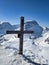 summit cross on the gemsfairen with a view of the piz russein toedi. Urnerboden. Winter mountain landscape. Peak