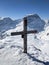 summit cross on the gemsfairenstock with a view of the piz russein toedi. Urnerboden. Winter mountain landscape. Peak