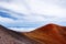 The summit of Mauna Kea, a dormant volcano on the island of Hawaii. Stunningly beautiful red stone peak hovering above clouds, the