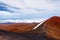 The summit of Mauna Kea, a dormant volcano on the island of Hawaii. Stunningly beautiful red stone peak hovering above clouds, the