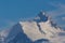 Summit of snowcapped Weisshorn mountain in Switzerland, blue sky