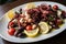 Sumptuous grilled octopus tentacles tossed with creamy feta cheese, diced tomatoes, and briny olives in a light lemon vinaigrette