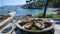 Sumptuous oysters on a plate with white wine by the sea, elegant outdoor dining experience, fresh seafood delight. AI