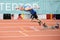 SUMY, UKRAINE - FEBRUARY 21, 2020: sportsman at the start of 200m race at Ukrainian indoor track and field championship