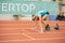 SUMY, UKRAINE - FEBRUARY 21, 2020: sportswoman at the start of 200m race at Ukrainian indoor track and field