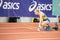 SUMY, UKRAINE - FEBRUARY 21, 2020: sportswoman at the start of 200m race at Ukrainian indoor track and field