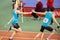 SUMY, UKRAINE - FEBRUARY 22, 2020: sportsmen handing over the baton in 4x400m relay at Ukrainian indoor track and field