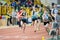 SUMY, UKRAINE - FEBRUARY 22, 2020: sportswomen handing over the baton in 4x400m relay at Ukrainian indoor track and