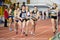 SUMY, UKRAINE - FEBRUARY 22, 2020: sportswomen handing over the baton in 4x400m relay at Ukrainian indoor track and