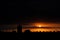 Sun appears from behind the clouds, roof top view of an old church tower.