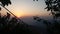 The sun appears on the top of siripade hill with the footprint of the buddha