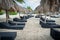 Sun beds/ lounge chairs and straw thatch roof umbrellas on tropical beach