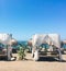 Sun beds on sandy beach coast, luxury Mediterranean resort as travel destination