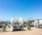 Sun beds on sandy beach coast, luxury Mediterranean resort as travel destination