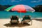 Sun beds under pastel colored umbrella on caribbean beach