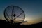 Sun behind satellite receiver in twilight