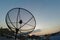 Sun behind satellite receiver in twilight