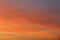 Sun below the horizon and clouds in the fiery dramatic orange sky at sunset or dawn backlit by the sun. Place for text and design