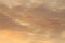 Sun below the horizon and clouds in the fiery dramatic orange sky at sunset or dawn backlit by the sun. Place for text and design