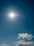 Sun in a blue cloudy sky. Vertical image for design purpose and sky replacement