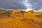 Sun Breaking Through the Clouds on a Colorful Sandstone Ridge