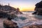 Sun breaking the horizon over a rocky cove on an  beach in Bermuda - Jobsons Cove