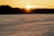 Sun Burst At Sunset Over A Frozen Lake