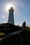 The Sun Bursts From Behind A Lighthouse In Nova Scotia, Canada