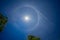Sun with a circular rainbow, Fantastic beautiful sun halo phenomenon and Jet steam out of clouds in Thailand