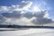 The sun comes out from behind the clouds over the frozen Neva River in St. Petersburg, opening up from the ice