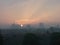 Sun is coming up and sunrise colors the Utrecht skyline orange due to the fog in the morning