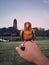 sun conure. very beautiful colorful birds. standing in the wind on the hand of a man.