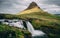 Sun covered kirkjufellsfoss waterfall with kirkjufell mountain in iceland. picturesque long exposure of famous iceland nature