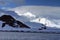 Sun dappled mountain in Antarctica with a science station below