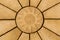 Sun design on golden coloured paving stone star pattern. Backgr