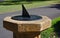 Sun dial mounted on a stone plinth