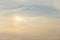 A sun dog atmospheric optical phenomenon in the sky, with birds flying in the distance