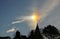 Sun dog and cirrus cloud above a church.