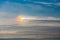 A sun dog, parhelion at a warm summer sunset