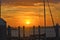 The sun dominates the horizon as seen from a small coastal fishing village in Florida