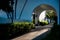 Sun-drenched archway surrounded by lush greenery