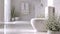 Sun-drenched bathroom with white subway tiles, toilet and sink next to a potted plant. Interior design, cozy lifestyle