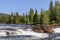 A sun-drenched summer view of the Namsen River in Namsskogan, Trondelag, Norway, featuring cascades