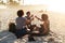 Sun, drinks, friends and the beach are all we need. an attractive young trio of women celebrating and having a drink