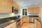 Sun filled gourmet kitchen with wooden cabinetry